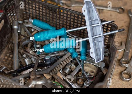 selective focus new screwdriver with blue handle In the car mechanic's tool tray Stock Photo