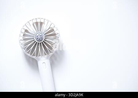 mini-electric-white-fan-with-handle-isolated-on-white-background-stock