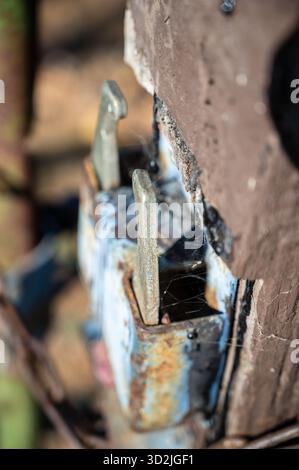Rusted rural gate latch on paddock fence gate Stock Photo