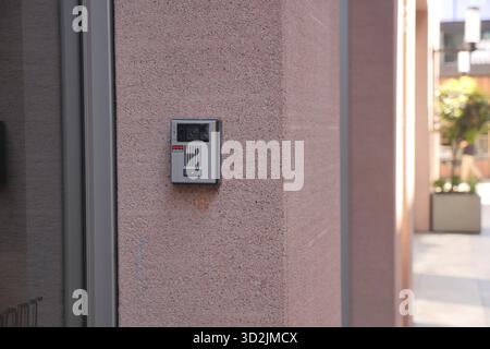 Modern intercom system installed on a smooth concrete wall Stock Photo