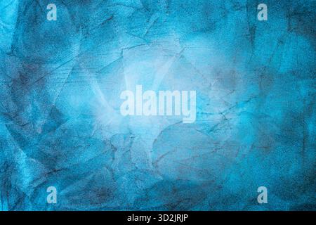 Charcoal and chalk smudges and smears on blue colored paper, abstract vignette backdrop, close up Stock Photo