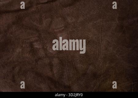 Genuine leather suede skin, textured surface, dark brown close up parchment structure Stock Photo