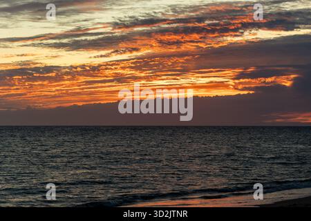 Sunset on the beach. View of the twilight over the sea. Landscape photograph on the Atlantic coast of Rota, Costa de la Luz, Cádiz, Andalusia, Spain. Stock Photo