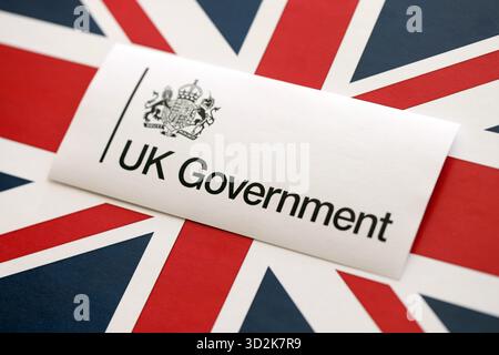 KYIV, UKRAINE - SEPTEMBER 17, 2025 Government GOV UK logotype sticker lies on UK flag close up Stock Photo