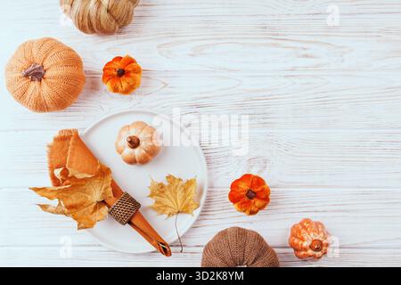 Thanksgiving Table Setting with Pumpkins and Autumn Leaves Stock Photo