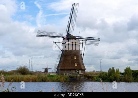 Historic windmills along the waterway in the village of Kinderdijk, a UNESCO World Heritage Site in the Netherlands. Stock Photo