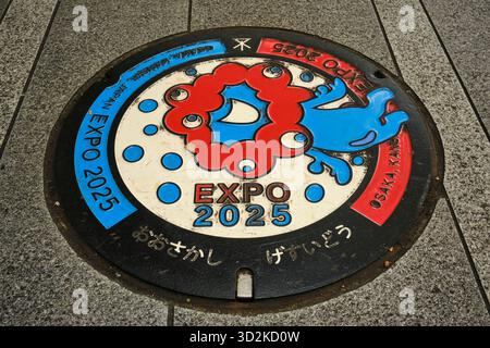 A manhole in Osaka decorated with the Osaka Expo mascot Myaku Myaku Stock Photo