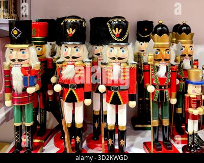 Colorful wooden nutcracker soldiers on store shelf, used for Christmas decoration and holiday interior design. Stock Photo