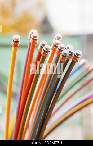 Bundle of colorful fiber optic cable against a blurred background, optical fiber Stock Photo