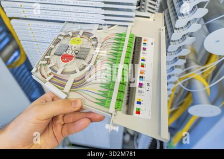 Close-up of a hand holding a fiber optic cabling module, optical fiber Stock Photo