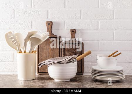 Stylish modern kitchen background. Environmentally friendly items and utensils on a dark marble countertop in the interior of a cozy kitchen Stock Photo
