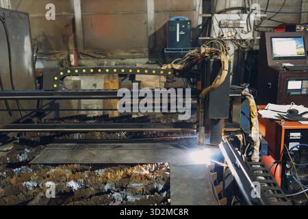 Automatic cnc laser cutting machine working with sheet metal with sparks. Metalworking industrial manufacturing factory Stock Photo