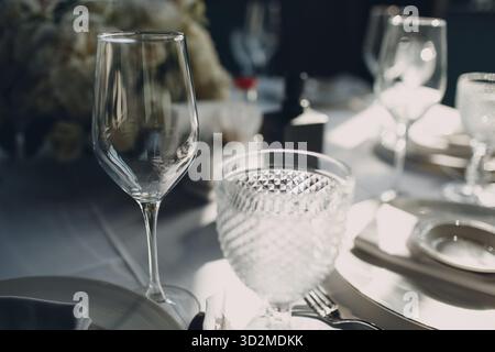 Beautiful shape empty wine glass on table in restaurant decor Stock Photo