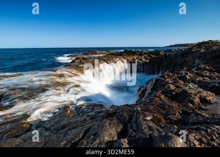 Dynamic long-exposure seascape of El Bufadero de La Garita on Gran Canaria, Canary Islands. Stock Photo