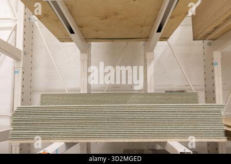 OSB wooden chipboard sheets stacked in store Stock Photo