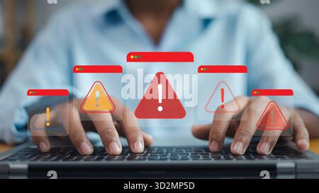 Person typing on laptop with multiple security alert warning windows, symbolizing cyber threat, data breach, system error, and online risk concept. Stock Photo