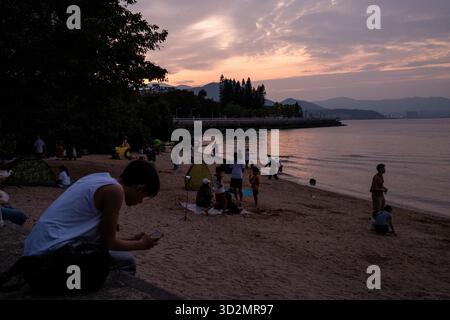 Hong Kong, Hong Kong. 02nd Nov, 2025. People watching the sunset on beach on November 2, 2025 in Hong Kong. (Photo by Vernon Yuen/Nexpher Images/Sipa USA) Credit: Sipa USA/Alamy Live News Stock Photo