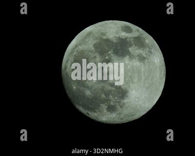 Full moon with detailed craters and shadows against black night sky Stock Photo