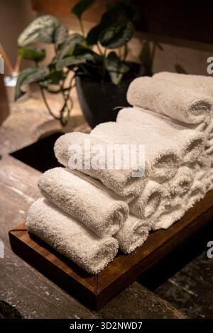 Stacked rolled towels for drying hands in a public bathroom Stock Photo