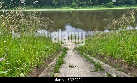View looking down the staircase from Schloss Pillnitz to the Elbe River, connecting the palace terrace with the grassy riverside. Stock Photo