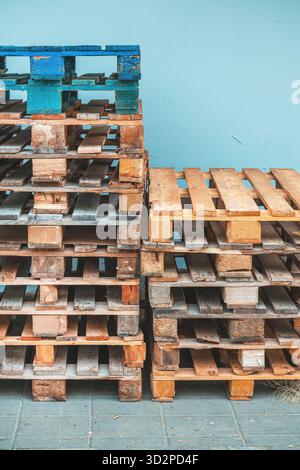 Pile of weathered euro pallets showing signs of wear and age. Selective focus. Stock Photo