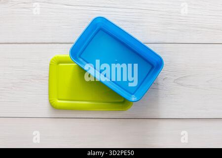 Empty plastic lunch boxes on white wood, top view Stock Photo