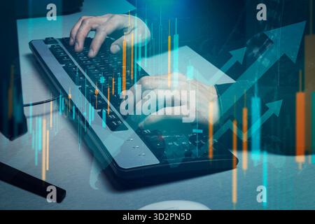 Close up to a male hands writing on a computer keyboard with blue and orange arrows and graphs of stock market double exposition concept Stock Photo