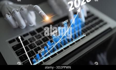 A robotic hand points at a digital graph on a laptop, illustrating growth and advancement in technology and finance, ideal for business and innovation Stock Photo
