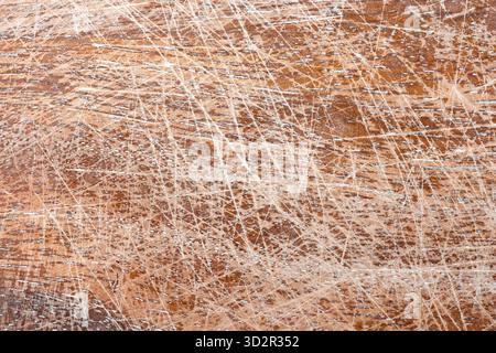 An intricate display of scratches and marks on a weathered surface. The texture highlights years of use, creating a unique and visually interesting pa Stock Photo