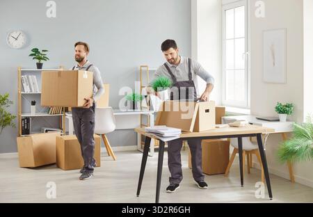 Two Movers Relocating With Boxes From Office Or Home Stock Photo