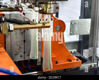 Manufacturing process of hollow glass tubes using advanced machinery in industrial facility Stock Photo
