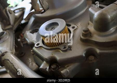 Close up detail of new oil filter for motorcycle engine part. technical view of vehicle maintenance, service, and repair with focus on clean replaceme Stock Photo