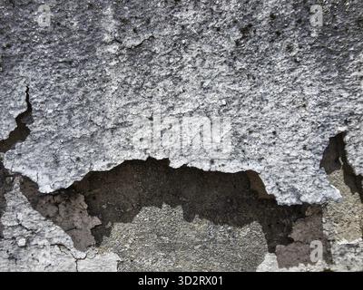 Aged gray texture of peeling stucco wall. Abstract background of old, damaged concrete surface, showing decay, crack, and weathered plaster material w Stock Photo