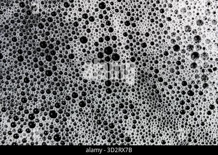 Captivating close up white foam bubbles forming mesmerizing abstract pattern. Diverse bubble sizes create rich, intricate texture. Effervescent surfac Stock Photo