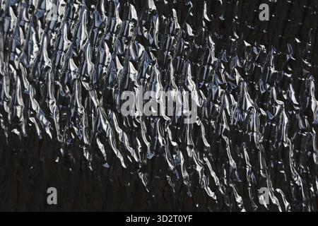 Black heat protection sheet insulation texture. An abstract background with detailed surface pattern. industrial material has wrinkled, glossy, and re Stock Photo