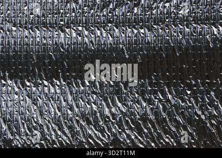Close up texture of silver metallic heat protection sheet background. This material offers insulation with reflective surface for industrial and futur Stock Photo