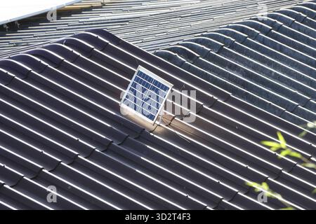 Single photovoltaic solar panel on corrugated roof. This clean, renewable technology generates sustainable energy, modern source of alternative power Stock Photo