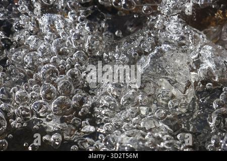Abstract background of fresh water bubbles in dynamic liquid flow. close up texture of clean, clear, effervescent water creating refreshing and energe Stock Photo