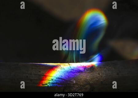 Mysterious abstract background showing vibrant spectrum of rainbow light. This colorful prism effect from light refraction creates an ethereal, magica Stock Photo