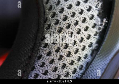 Close up macro view of black and grey fabric texture. technical mesh material reveals detailed pattern, perfect background for modern textile or shoe Stock Photo