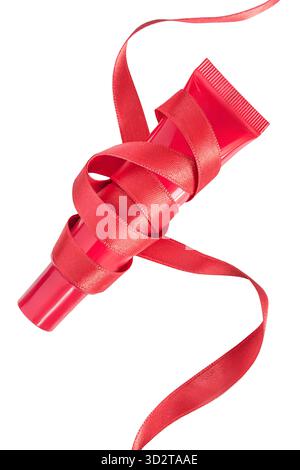 Red lip gloss tube tied with red satin ribbon isolated over white Stock Photo