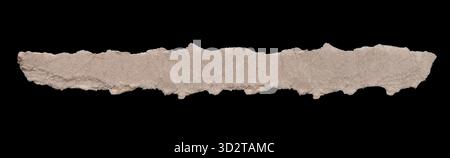 Isolated horizontal strip of torn light brown cardboard paper runs across the center of the image on a black background and clipping path. Stock Photo