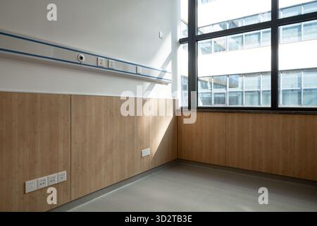 hospital room corner with wooden panels and large windows Stock Photo