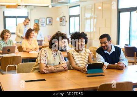 Diverse startup team collaborating in modern coworking office Stock Photo