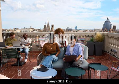 Diverse business team collaborating on barcelona rooftop Stock Photo