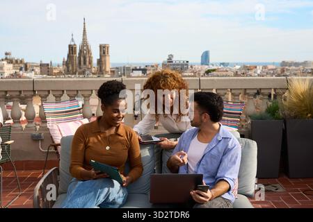 Diverse business team collaborating on barcelona rooftop Stock Photo