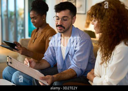 Diverse business team collaborating during an informal meeting - Financial, insurance and legal advisory Stock Photo
