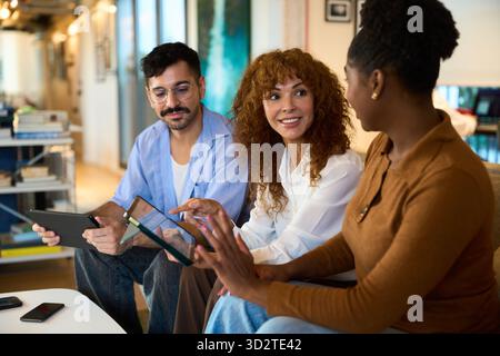 Diverse colleagues collaborating on digital tablets in office - Financial, insurance and legal advisory Stock Photo
