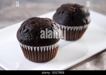 Chocolate muffins on wooden table Stock Photo