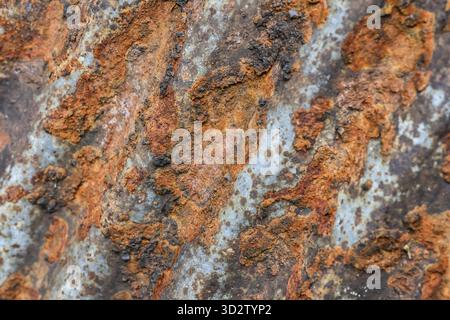 Abstract background of rough metal texture with severe rust and corrosion. surface shows signs of decay and aging, creating worn and gritty pattern Stock Photo